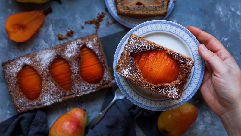 Pear cake and fruits on table