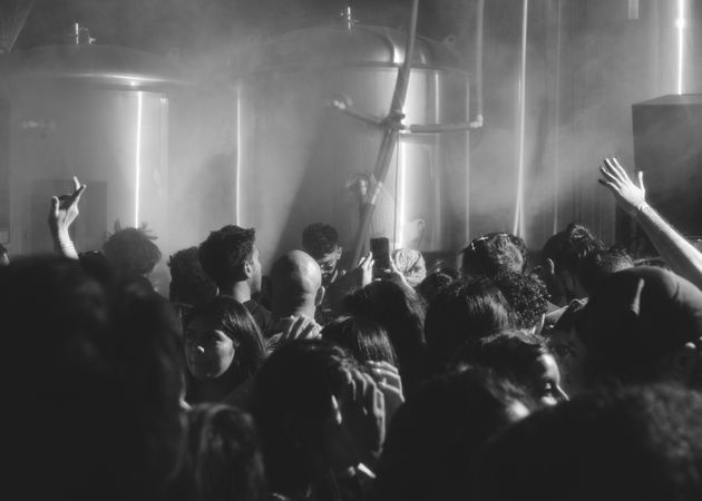 London, England, United Kingdom - Nov 9, 2022: B&W shot of crowd at party in brewery