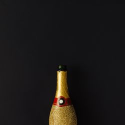 Golden champagne party bottle on background