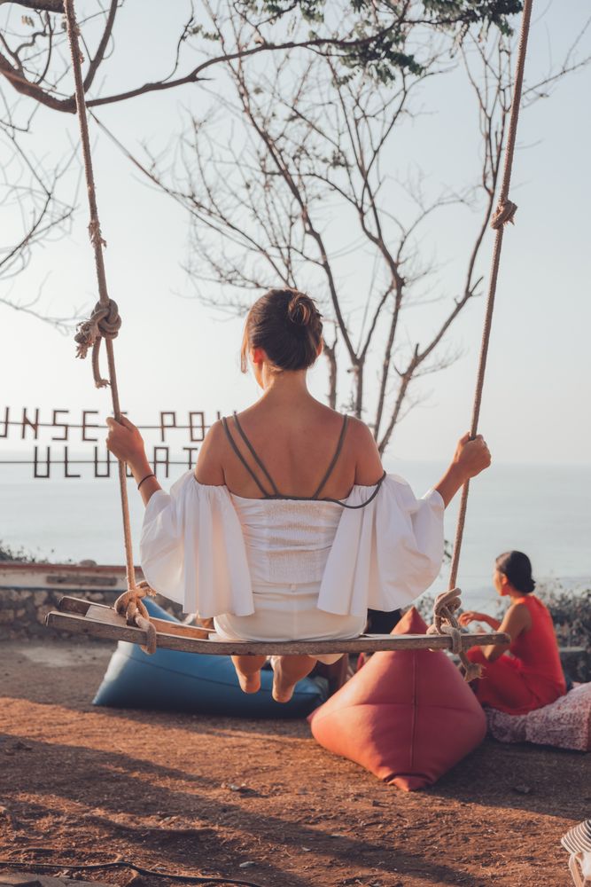 Young woman sitting on swing