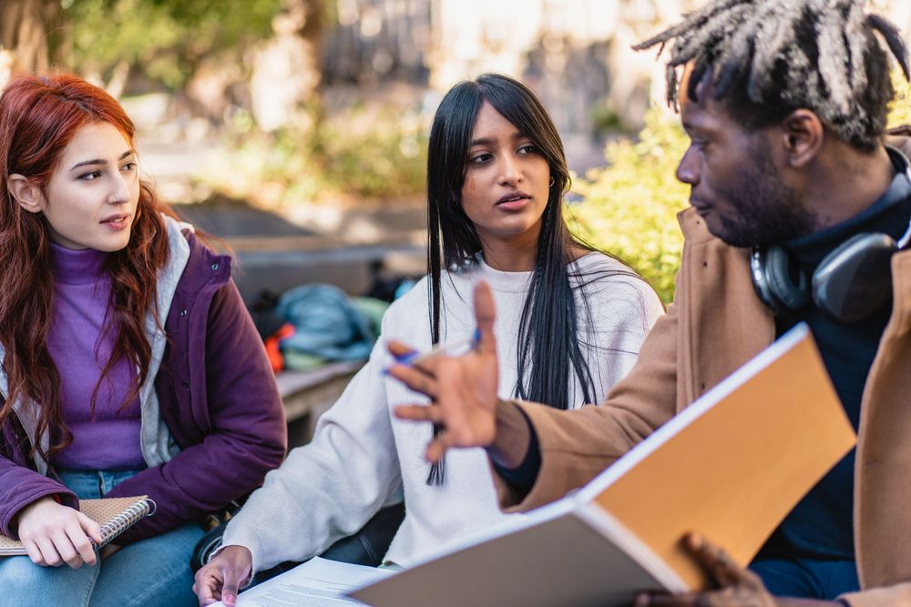 Diverse students studying outside