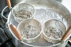 Process of cooking noodles in saucepan with boiling water