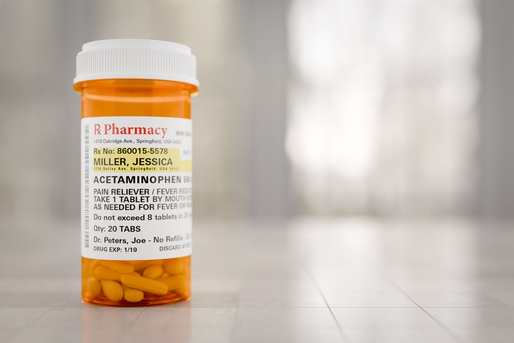 Acetaminophen Prescription Medicine Bottle Resting On A Bathroom Countertop.