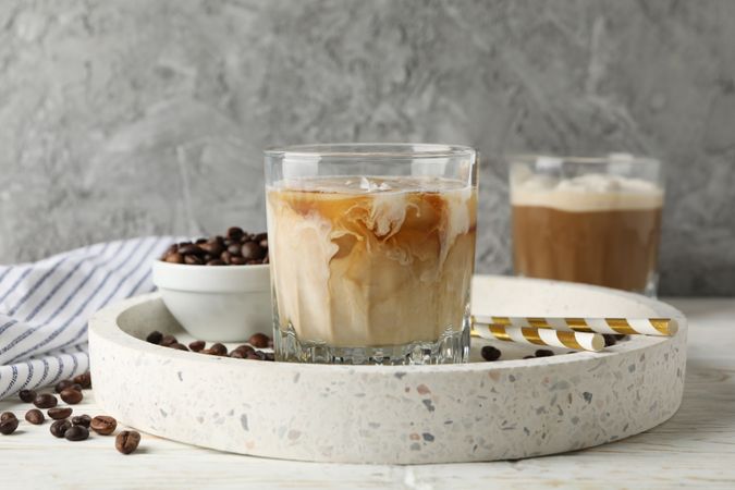 Composition with tray with ice coffee on wooden background