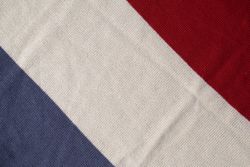 Triple color grey milk and red on knitted fabric background texture.