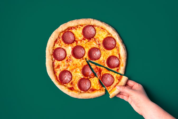 Homemade pizza salami isolated on a green background