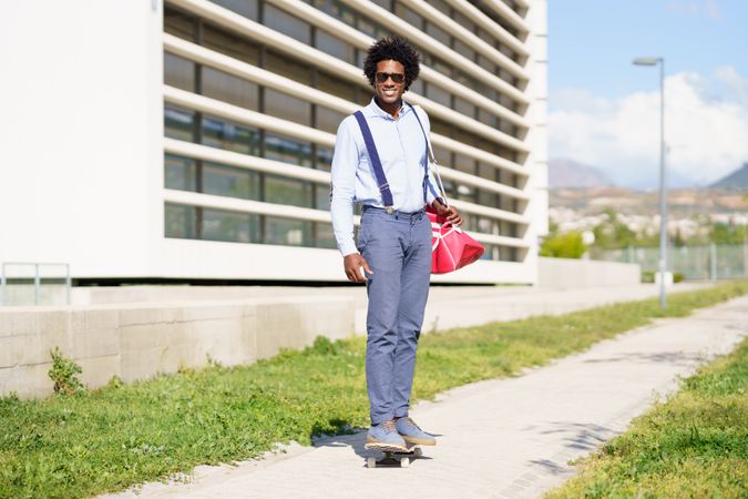 Man riding skateboard outside office building