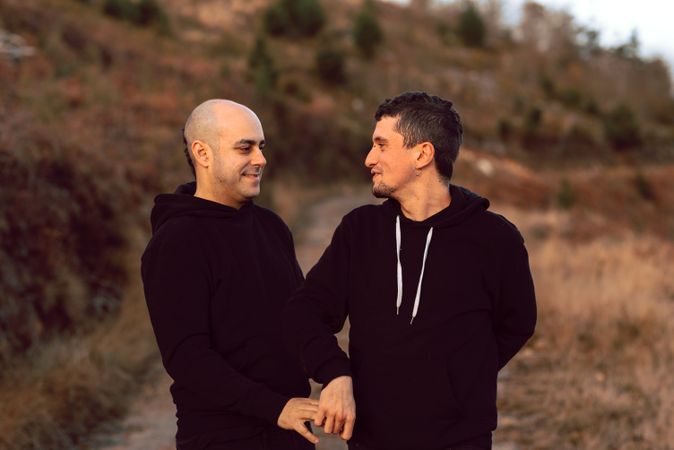 Men hugging in forest