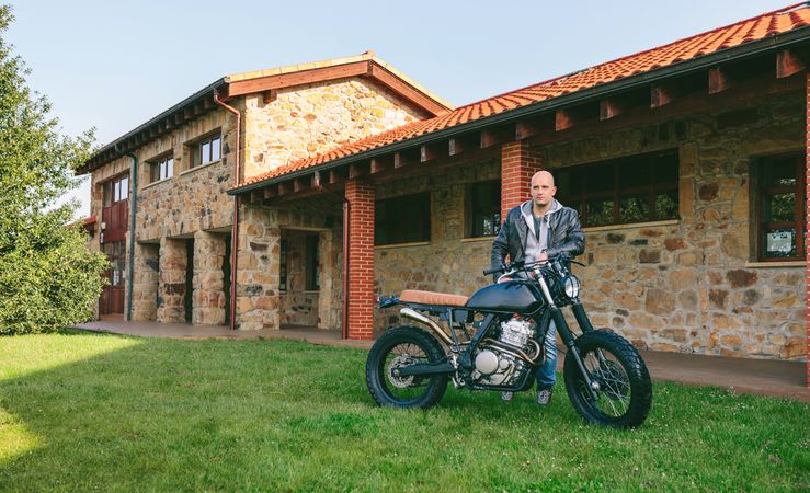 Man posing with a custom motorbike