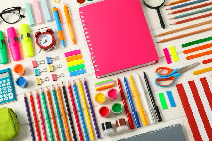 Flat lay composition with school supplies on wooden background