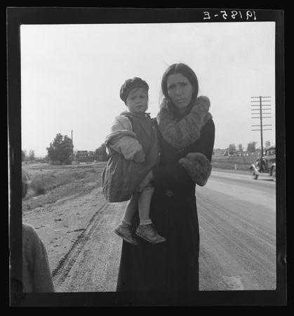 Homeless mother and youngest child of seven walking the highway from Phoenix, Arizona, Feb 1939