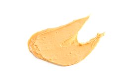 Creamy peanut butter isolated on bright background. A traditional product of American cuisine