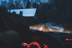 Crop hand driving car in winter village