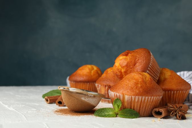 Composition with muffins and cinnamon on light background