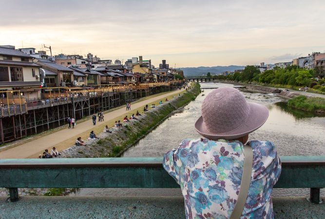 Japan - May, 10 2013: Anonymous person looking at river and town