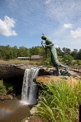Waterfall and bronze Native American statue at a in Alabama
