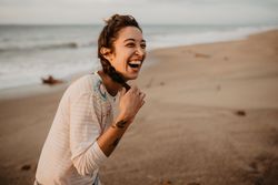 Young woman laughing on beach