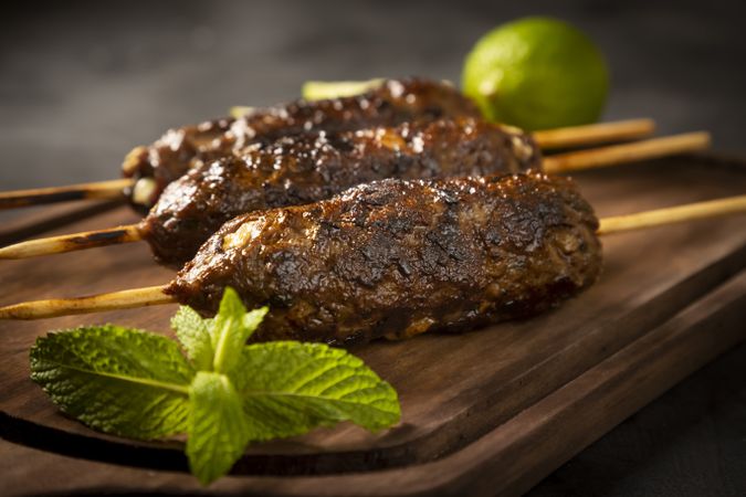 Beef kafta on the wooden board. Kafta, Traditional Arabic cuisine.