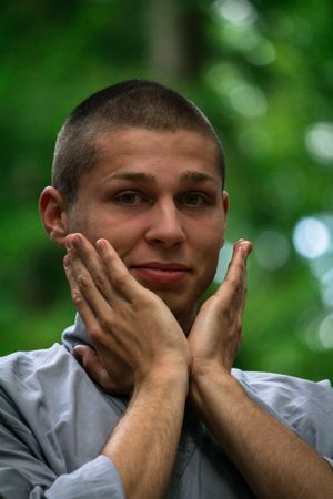 Young man meditating in garden