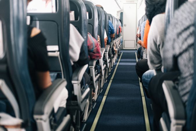 Rows of full airplane seats with anonymous people