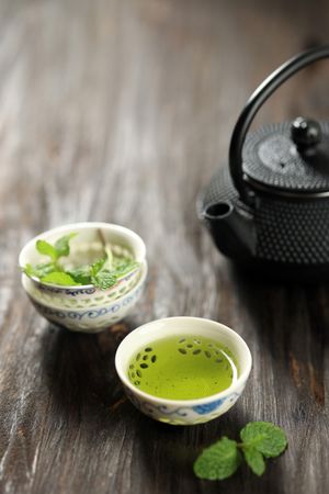 Japanese Green Tea on Small Ceremonial Cup and Cast Iron Teapot