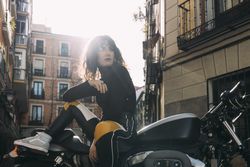 Young woman in custom motorbike