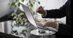 Businessman Working on Laptop at Office Desk