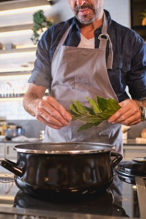Crop man cooking in kitchen
