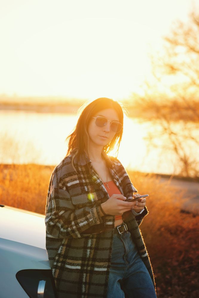 Woman near car use mobile app map