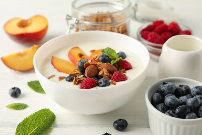 Flat lay composition with parfaits dessert and ingredients on wooden background