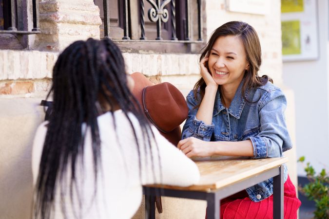 Female friends sitting on a table outdoors