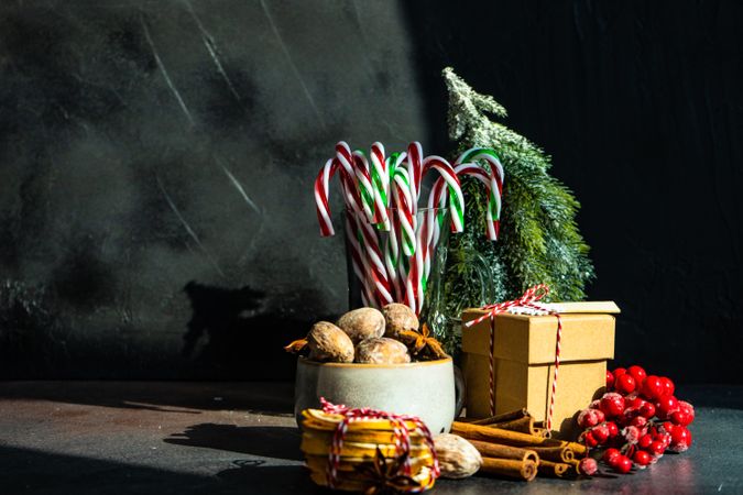 Christmassy scene with dried fruit, strings, cinnamon and holly with copy space