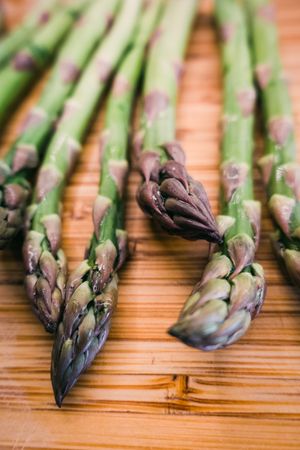 A bunch of green asparagus on wooden surface