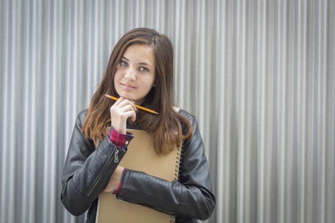Melancholy Female Student With Books Looking to the Side