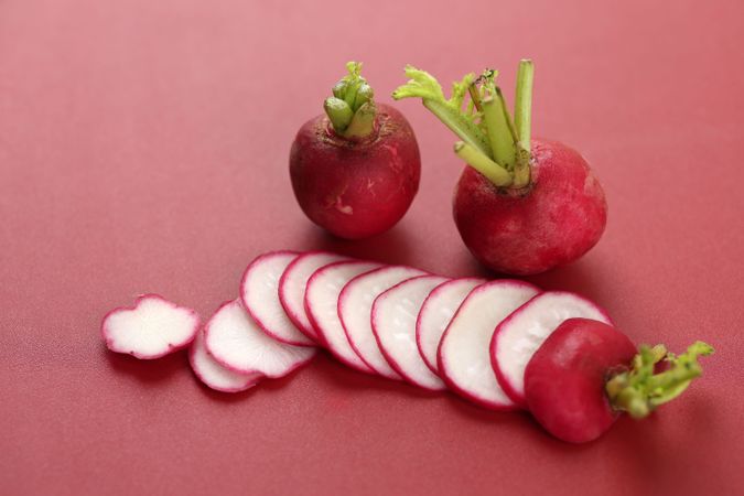 Sliced Red Radish on Red Background
