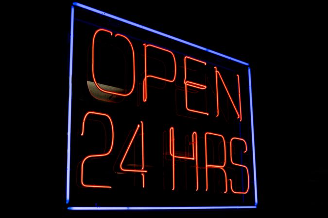 Neon sign open 24 hrs in dark