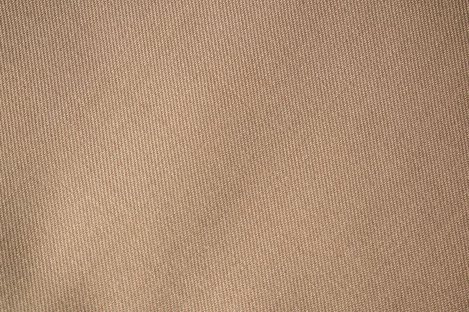 Detailed flat view Light brown pattern fabric texture background.