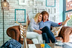 Couple taking selfie on a sofa