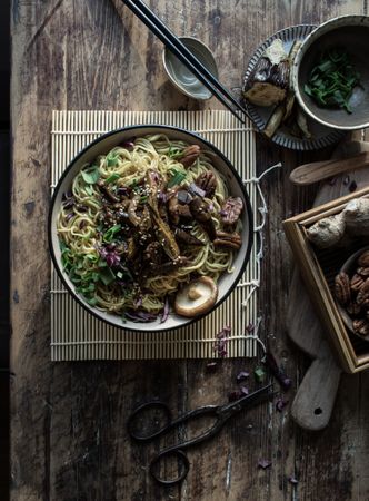 Miso noodles with egg plants and shiitake in bowl on table