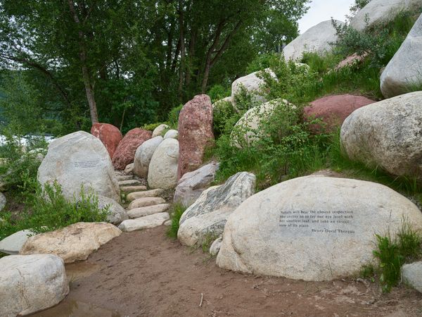 Walkway through boulders inscribed with quotes