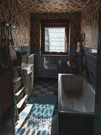 Interior of an old village house. Old furniture, chandelier, bathroom, old things, old dishes, glasses.