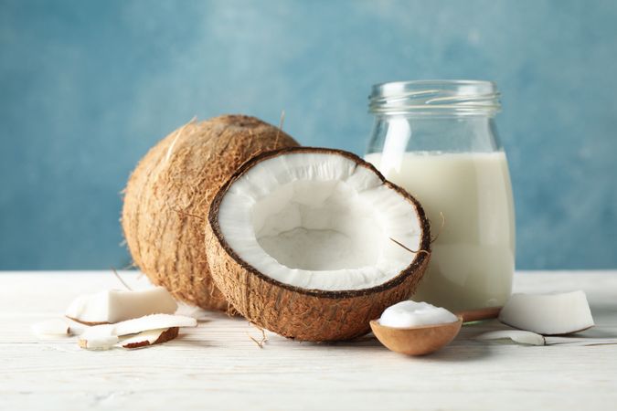 Coconut and milk on wooden background. Tropical fruit