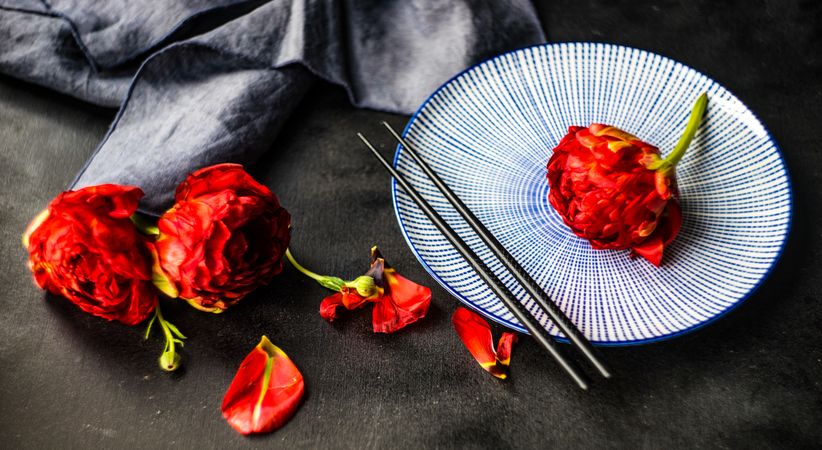 Red flowers with blue plate and chopsticks