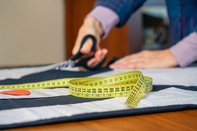 Measuring tape with dressmaker cutting in background