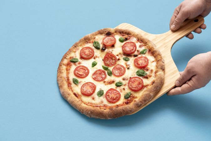 Freshly baked pizza on a wooden board