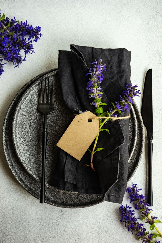 Summer background with blue flowers on dark table setting