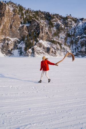 Woman enjoying winter day in snowy valley