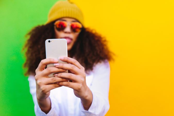 Stylish woman taking a selfie using mobile phone