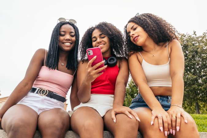 Black Friends Enjoying Summer Together and using smartphone