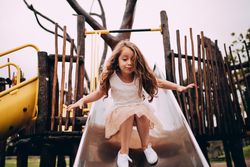 Little girl coming down the slide